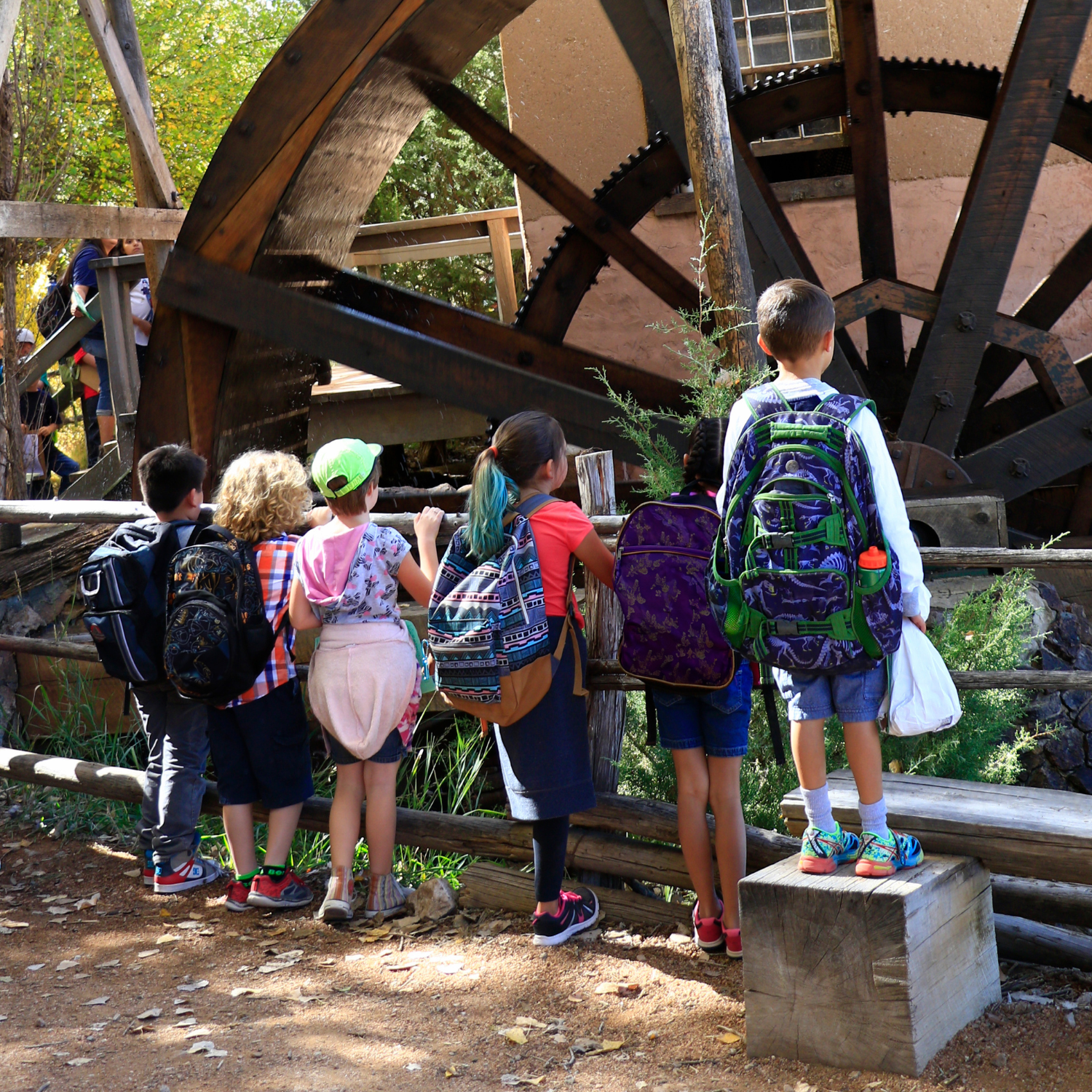 Children watching the mill operate during New Mexico Heritage Days at El Rancho de Las Golondrinas